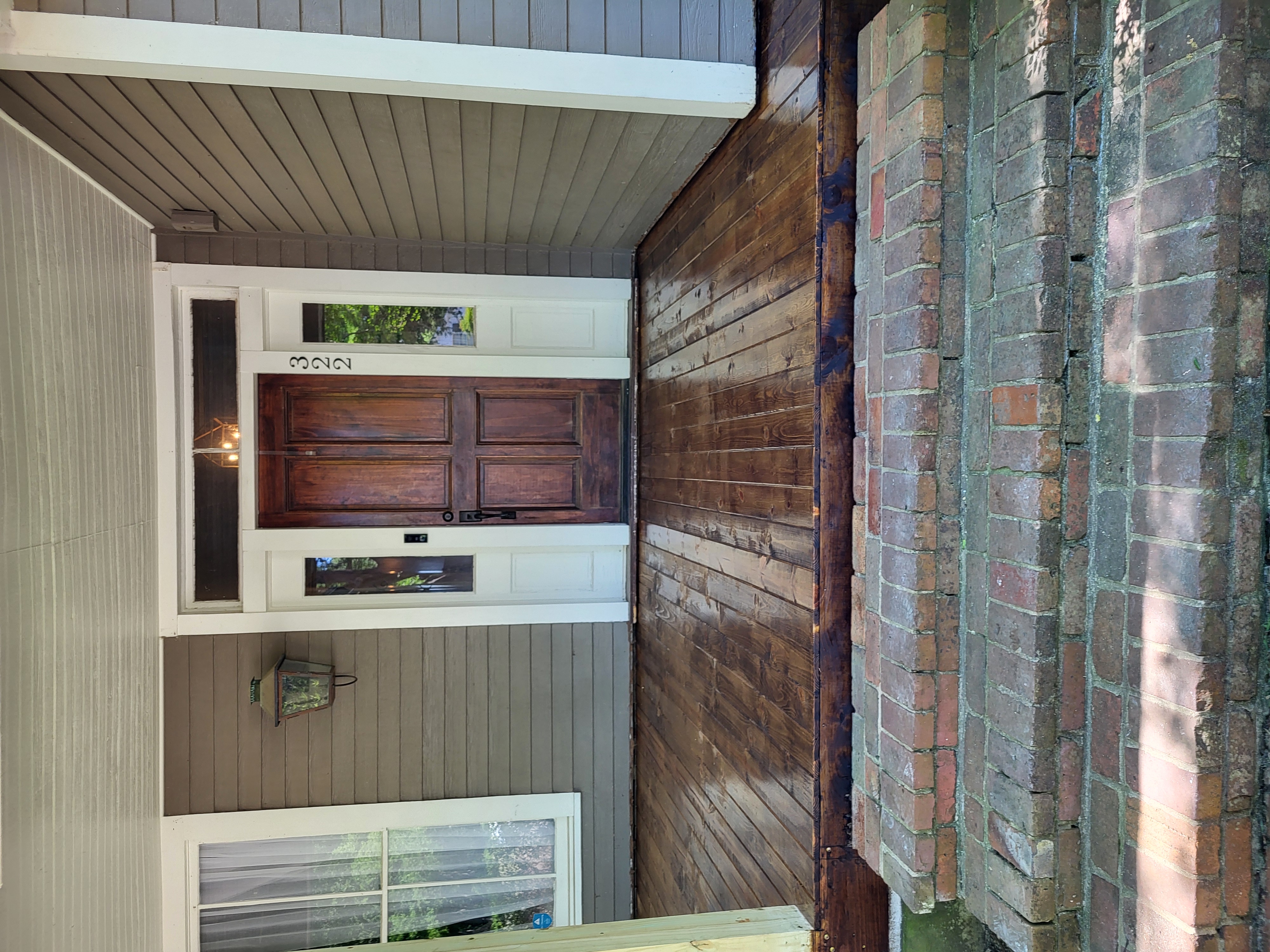 Porch front with wood siding and door